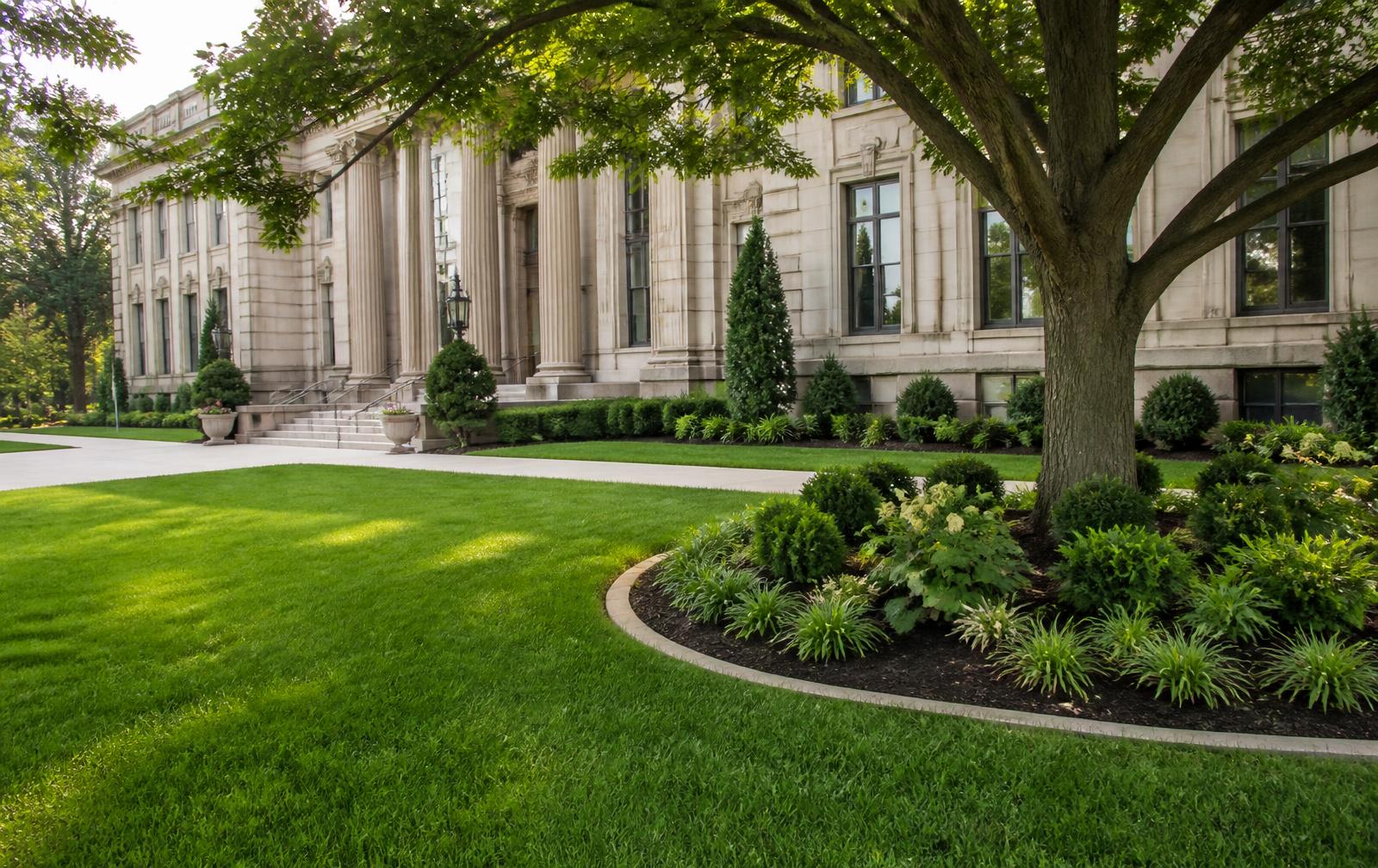Well-maintained civic grounds with manicured lawn and classical building